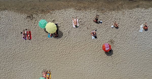 Kuşadası&#039;nda denize sosyal mesafe kurallarına uyularak giriliyor